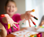 Nursery children playing with teacher in the classroom