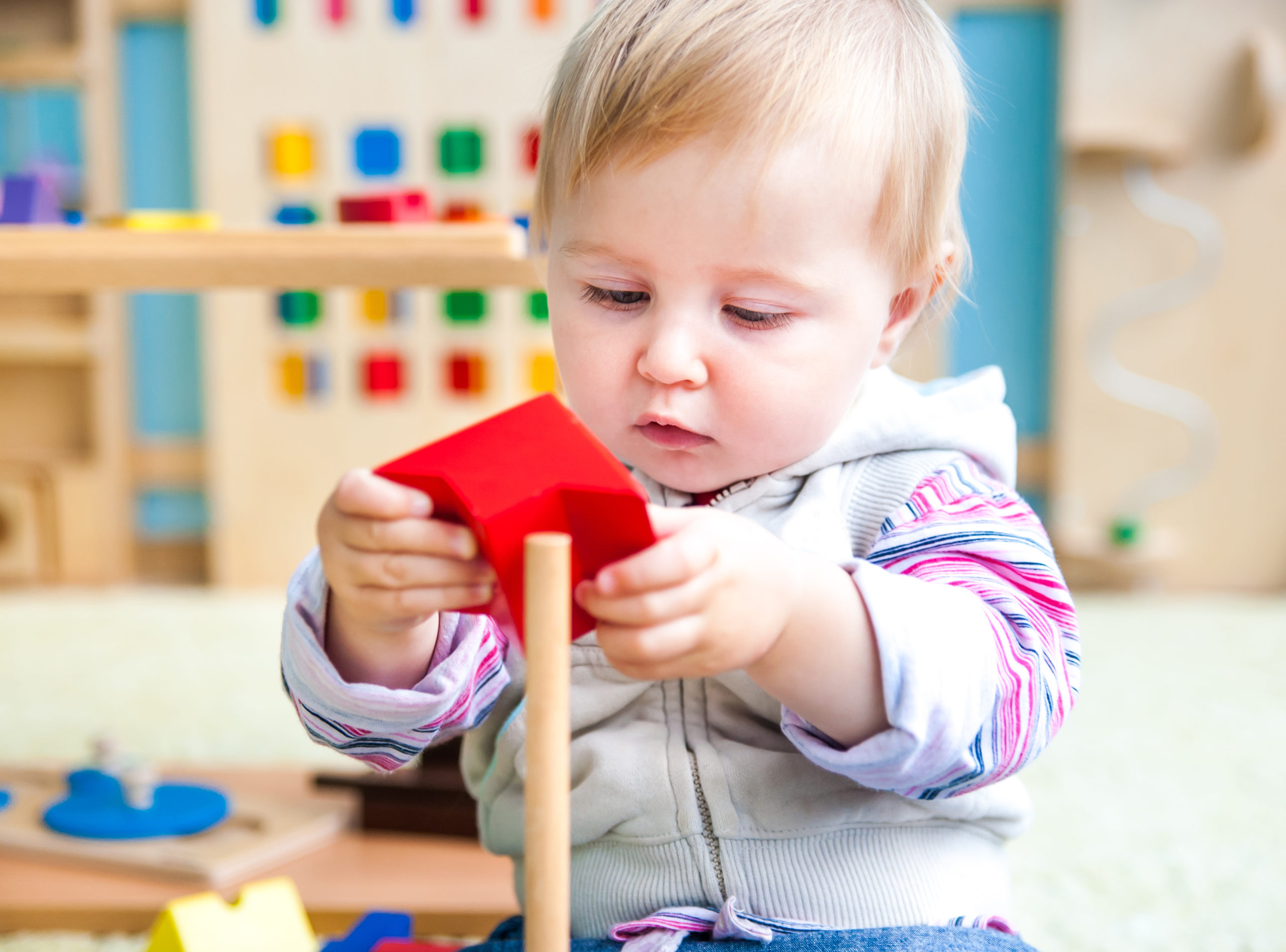 cute little girl in the classroom early development plays with b